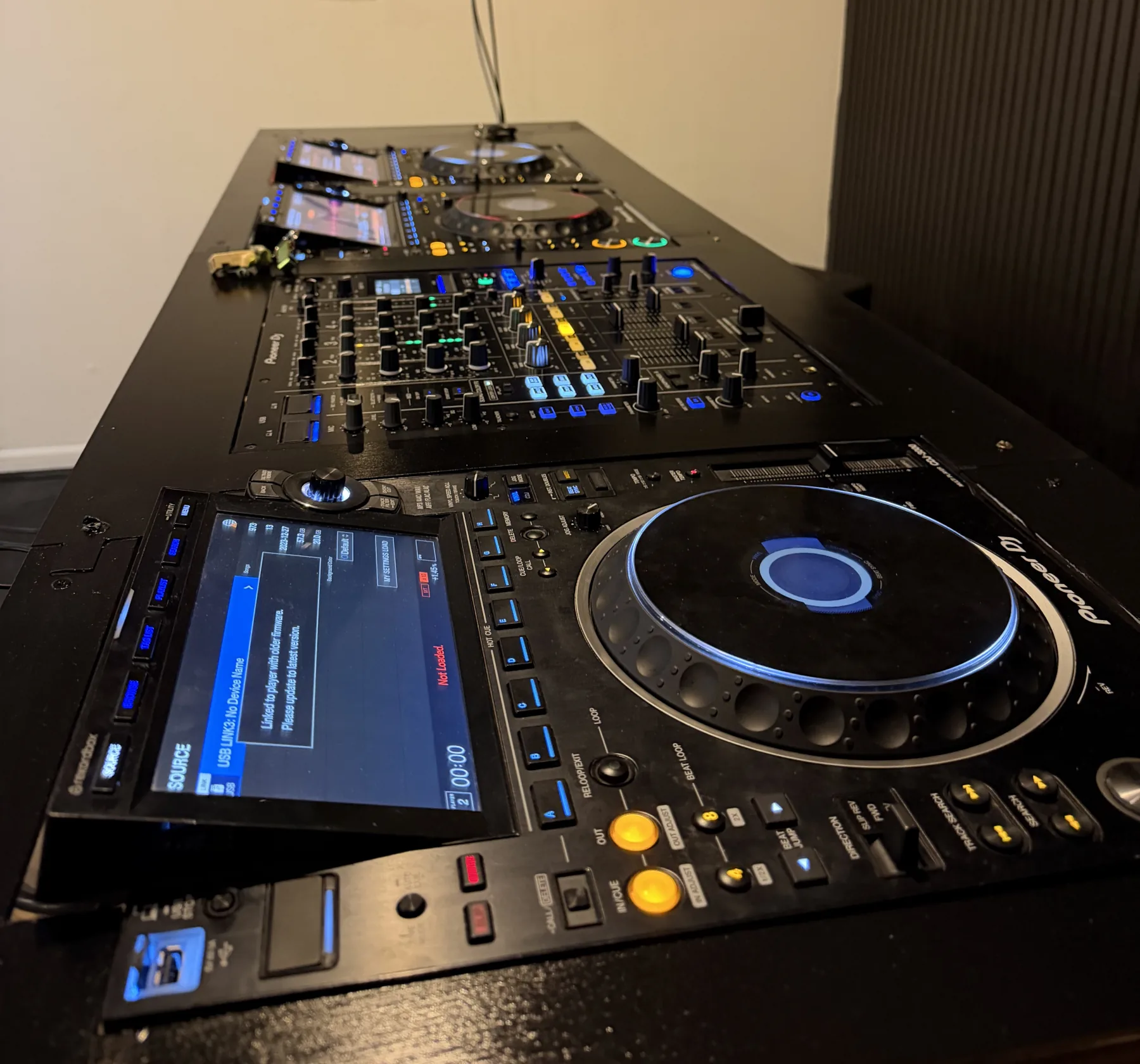 Unit 20 booth: four Pioneer CDJ-3000s linked to a DJM-A9 mixer on a black desk